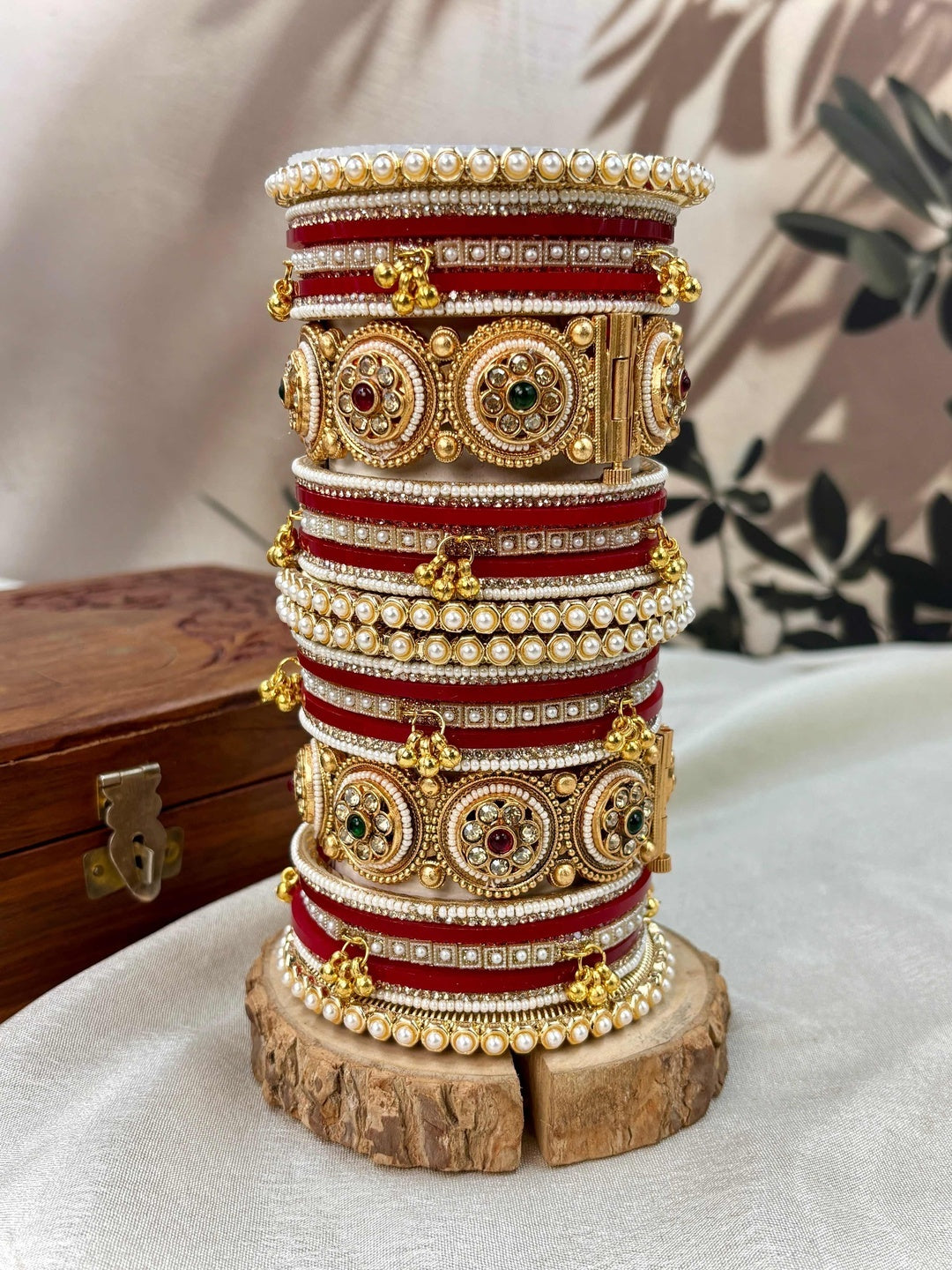 Ishhaara Traditional Kundan Bangle Bracelet Set - Close-up of a woman's hands adorned with red and gold bangles - view 7
