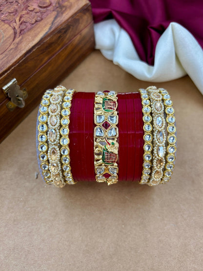 Ishhaara Traditional Kundan Bangles Set - a stunning stack of red and gold bangles with intricate designs and stones