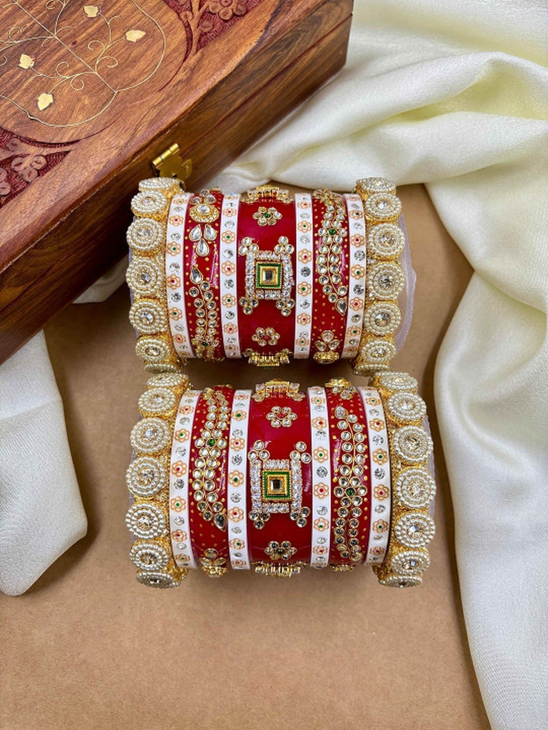 Ishhaara Traditional Red Kundan Bangles - A pair of intricately designed red bangles with gold and white accents