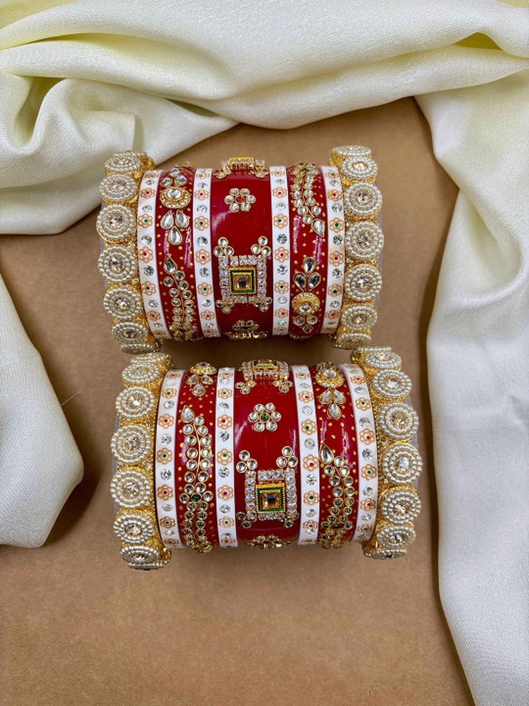 Ishhaara Traditional Red Kundan Bangles - A pair of intricately designed red bangles with gold and white accents - view 2